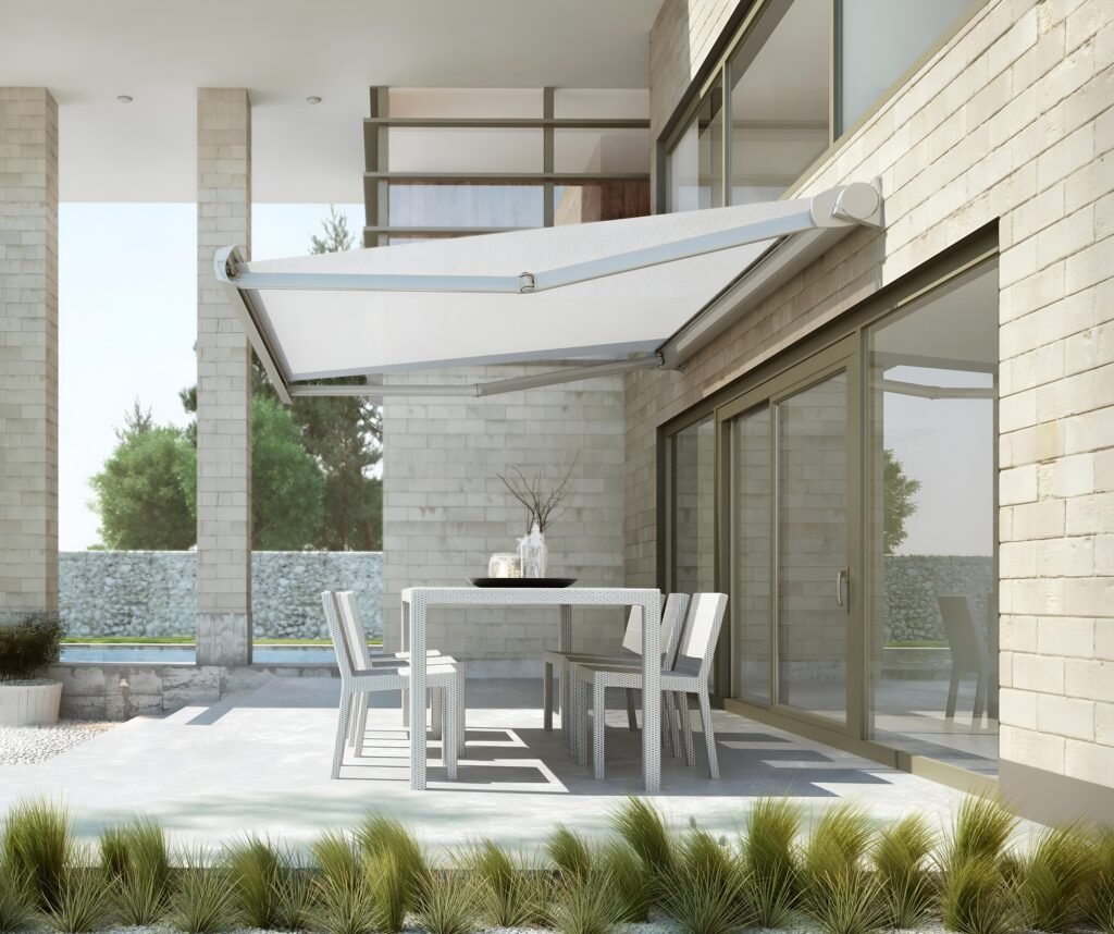 Modern patio sitting area with a luxury motorized awning providing shade and comfort for outdoor relaxation.